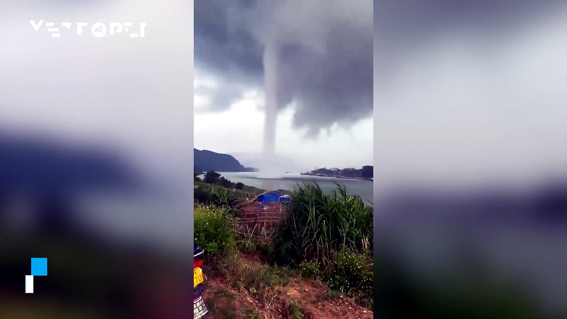 A large waterspout descends over the Yunfu Reservoir (Guangdong), China