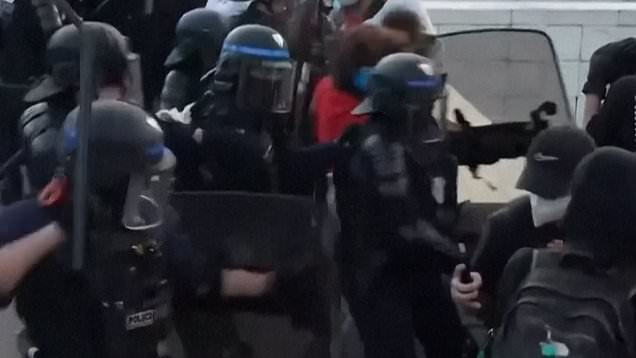 French riot police use tear gas and charge protesters with batons in Paris