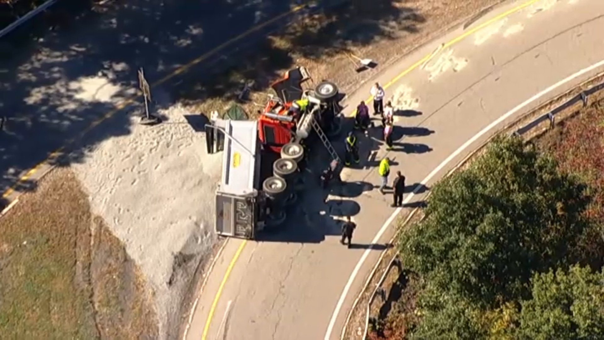 Dump truck tips over on Weston I-95 ramp, spilling debris and shutting road