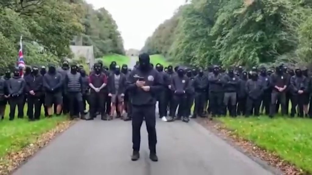 Police break up 100 masked 'patriots' delivering anti-migrant message ...