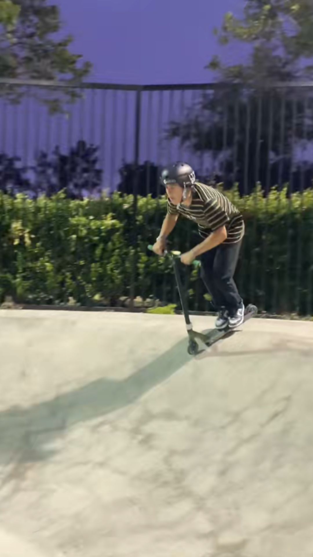 A scooter rider takes bowl tricks to new heights after dark