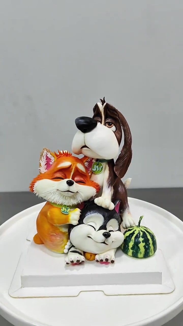 Adorable fox, dog and cat cake creates a whimsical animal scene