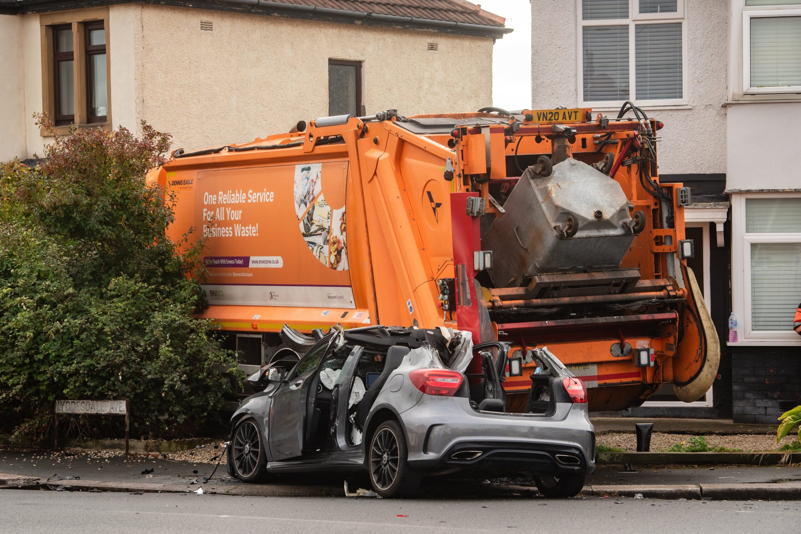 Bin lorry smashes into cars and home as driver arrested over suspected ...