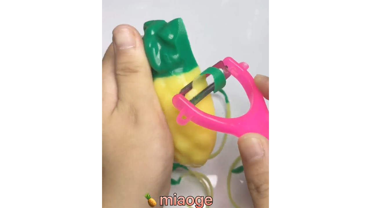 Peeling two tone soap into long emerald ribbons