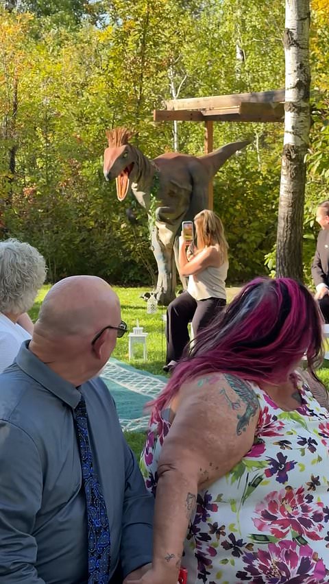 Dinosaur ring bearer surprises guests at wedding