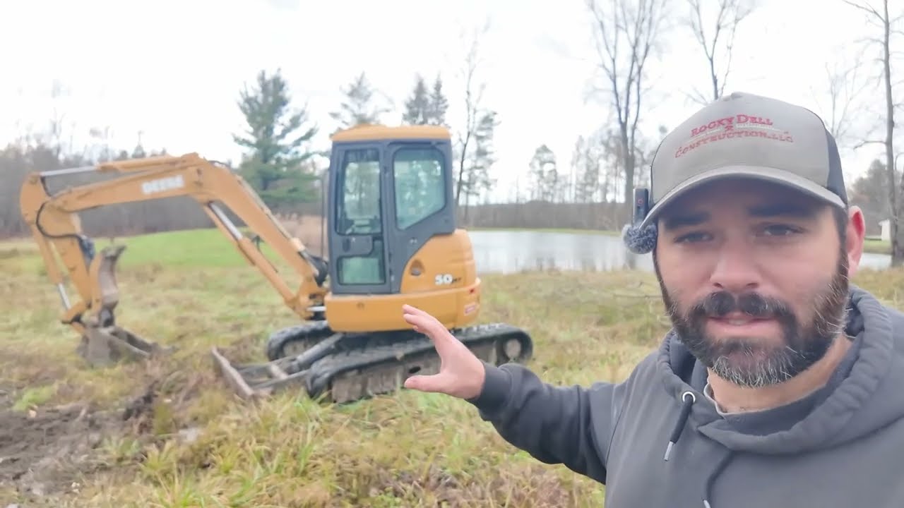 Removing dead trees with a mini excavator