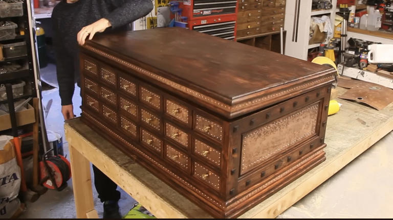 He turns old wood pallets into a rustic, steampunk-inspired storage chest