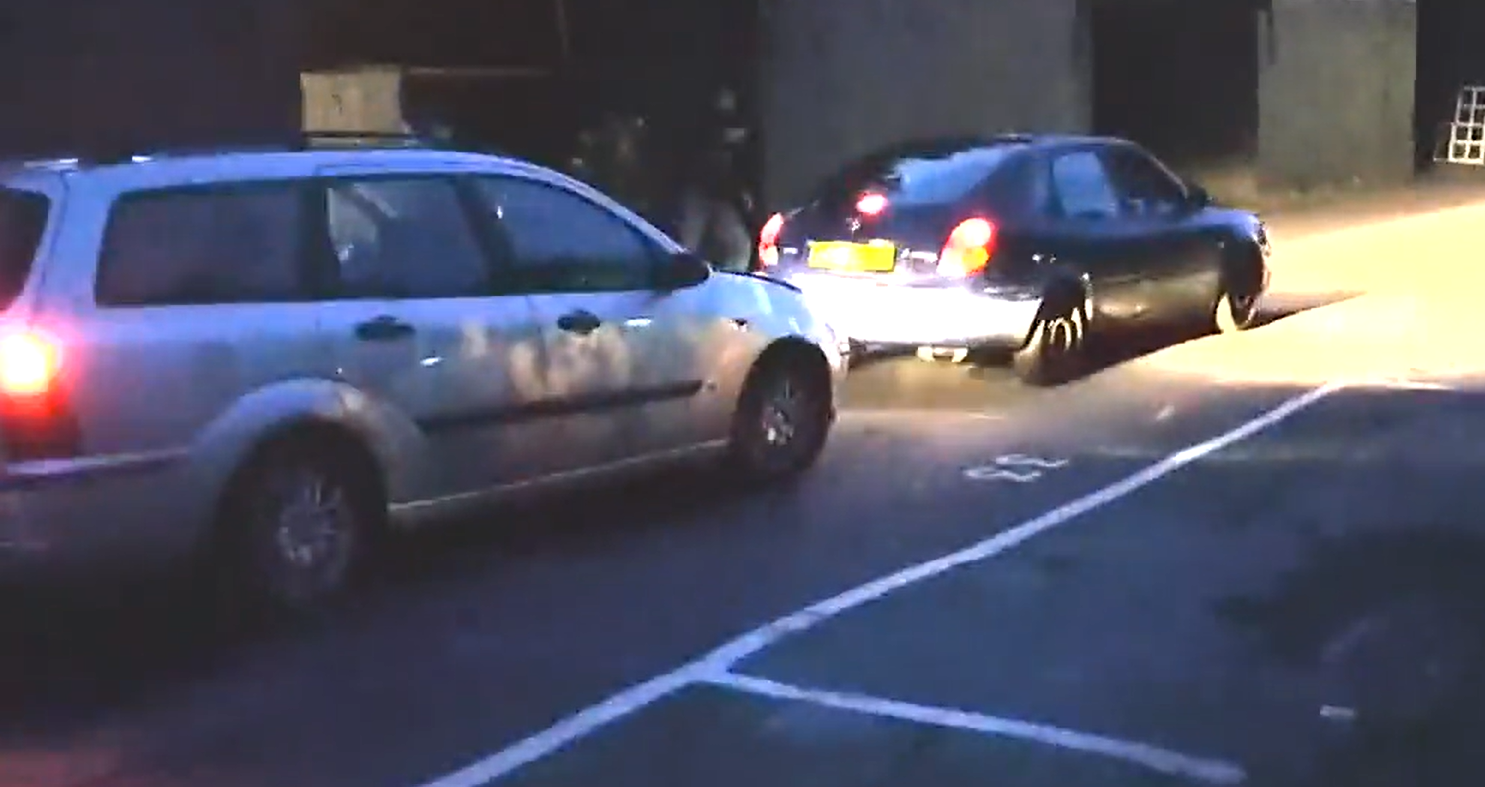 Watch a group pretend to pull a rope across the road then a car ...