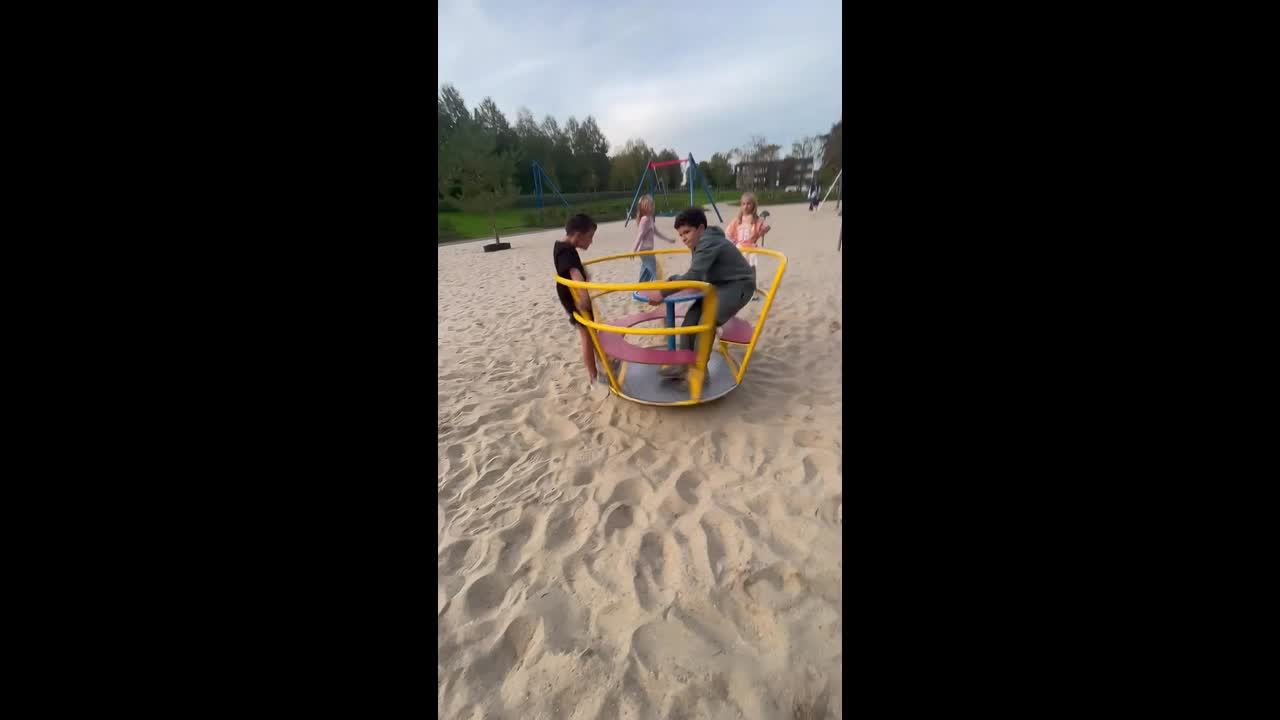 Children spin playground ride at high speed in Oisterwijk, Netherlands