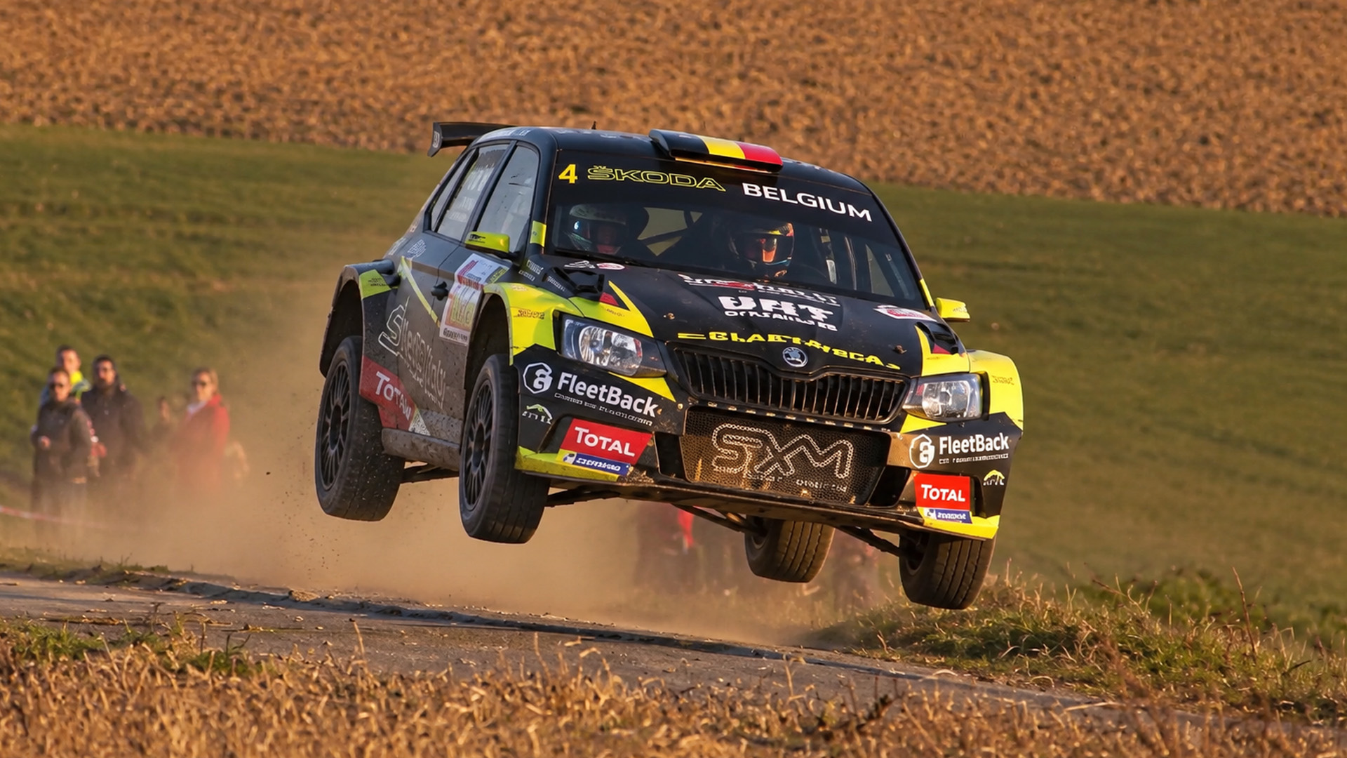 Fast rally cars slide through tight corners at Haspengouw