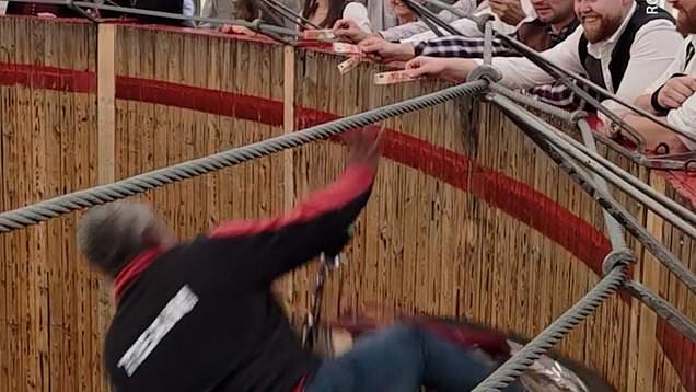 Wall of death biker grabs cash from spectators