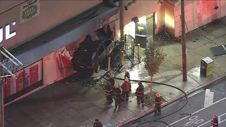 Driver dead after car goes airborne, slams into side of building in ...