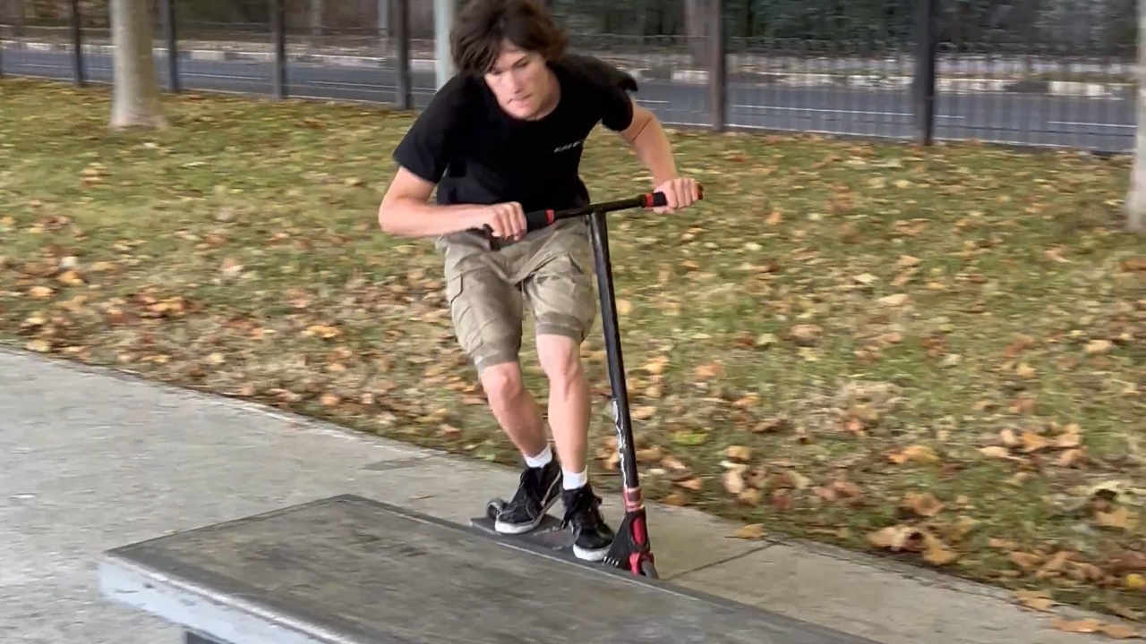 Boy loses control of scooter after jumping on bench