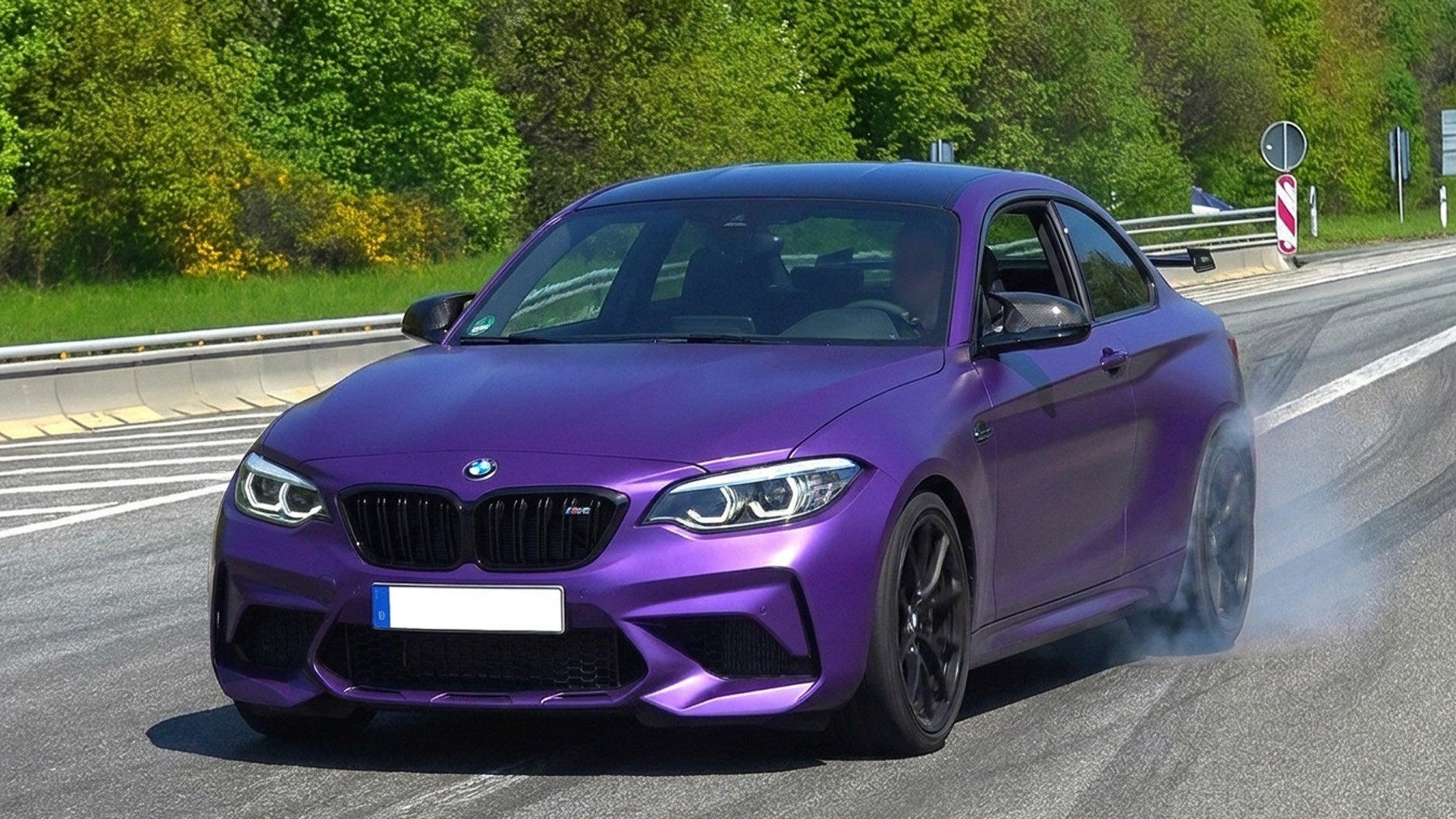 Purple BMW M2 slides away from the Nürburgring