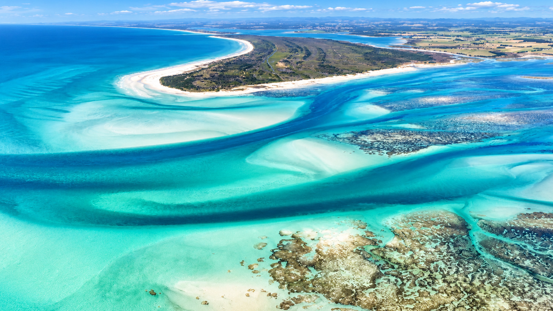 A coastal landscape that looks painted from above