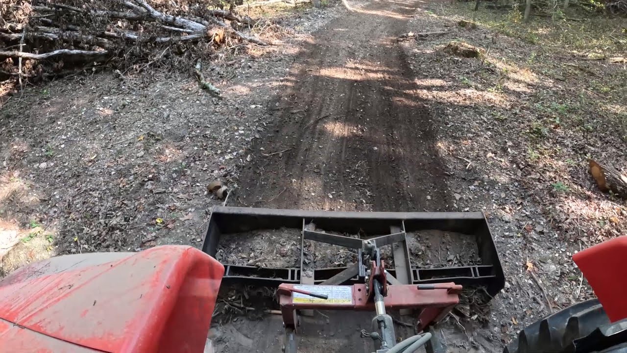 Old tractor box blade levels deep woods logging roads