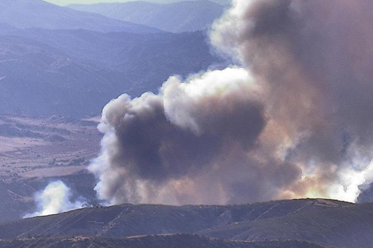 Fast-moving wildfire shuts down major California freeway as flames rage