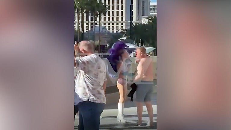 A shirtless man walks away from a woman dressed as a showgirl during a confrontation on the Las Vegas Strip on Sept. 30, 2026. Two women were arrested after police said a dispute over a $20 tip turned violent. Fox News