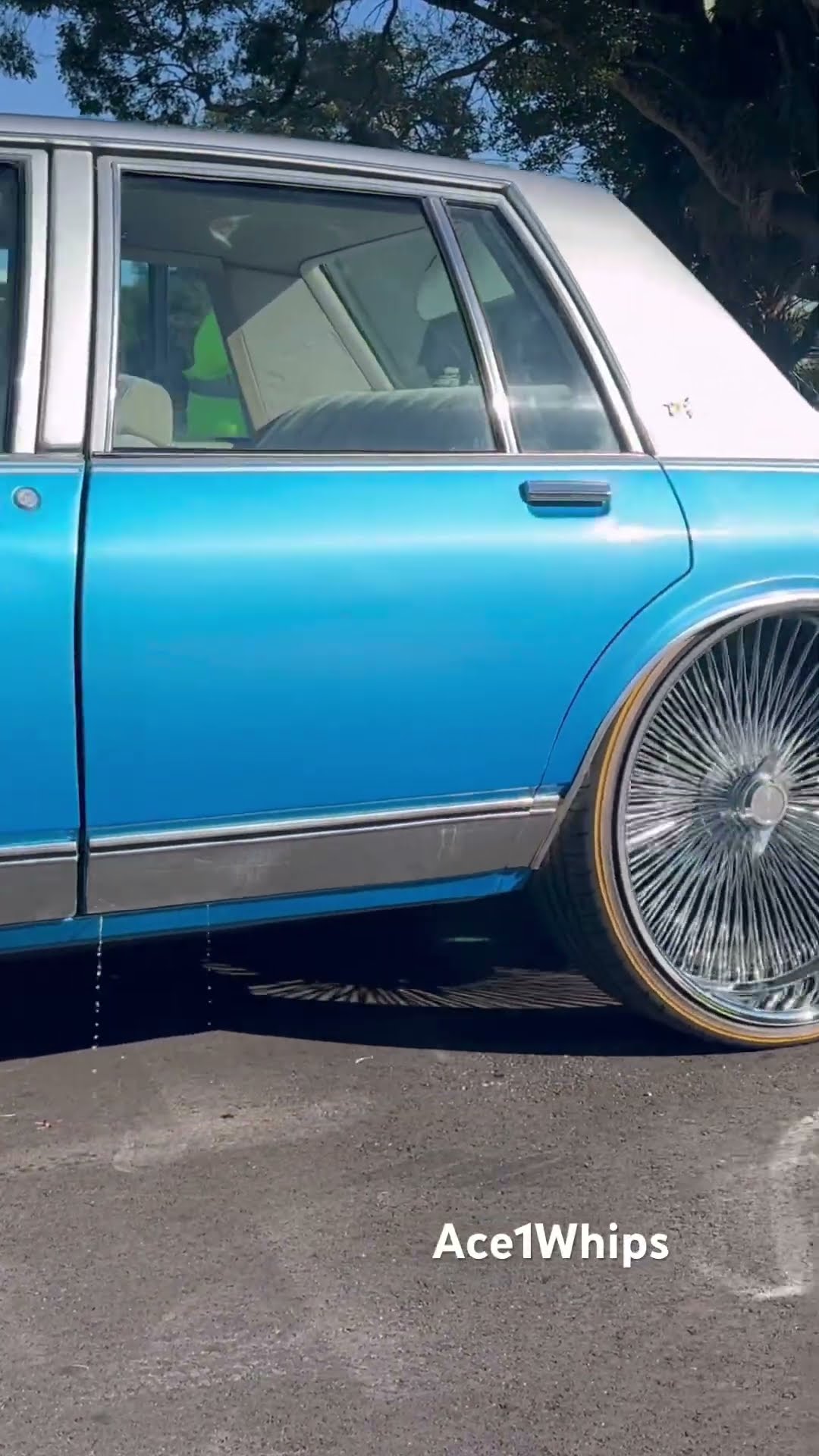 Silver and blue Chevy Caprice on 26’s wire wheels