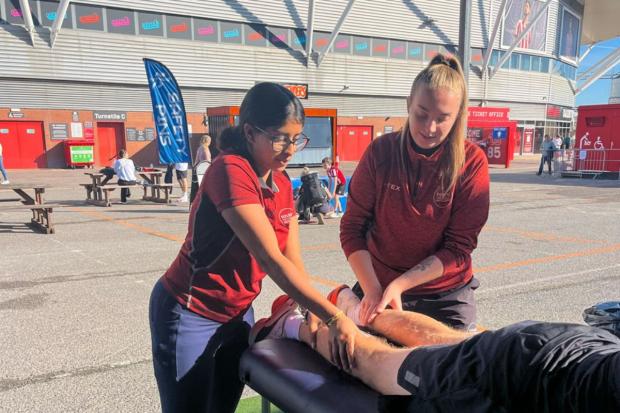 Solent students support runners with warm-ups and sports massage