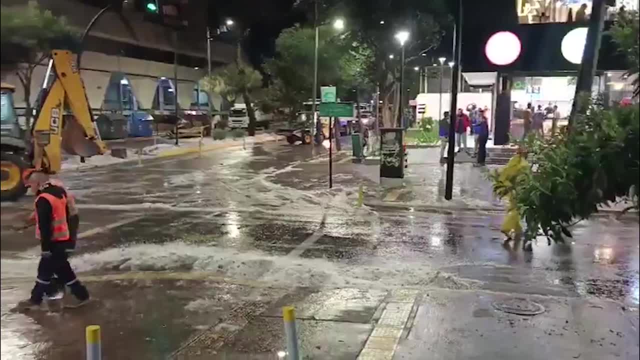 Diggers clear drifts of hail from Quito avenue after historic storm ...