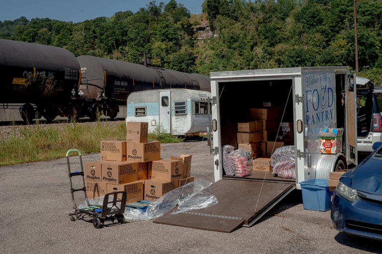 A stack of food boxes for seniors sat outside Donna Paterino's trailer in Williamson. Paterino packed them up to hand out later that afternoon to local seniors. (Mike Belleme for NBC News)