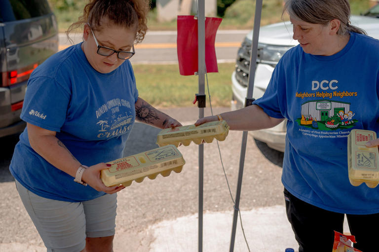 Staff members and volunteers gave each car two cartons of eggs at the food distribution in Dunlow. (Mike Belleme for NBC News)