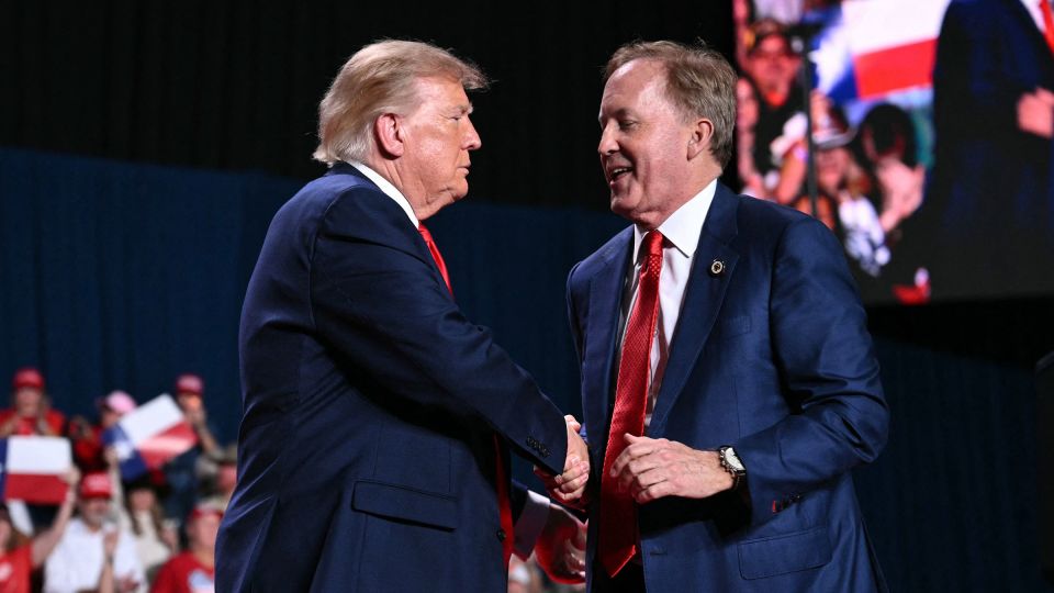 President Donald Trump shakes hands with Ken Paxton during a campaign rally in San Antonio on October 7. - Mandel Ngan/AFP/Getty Images