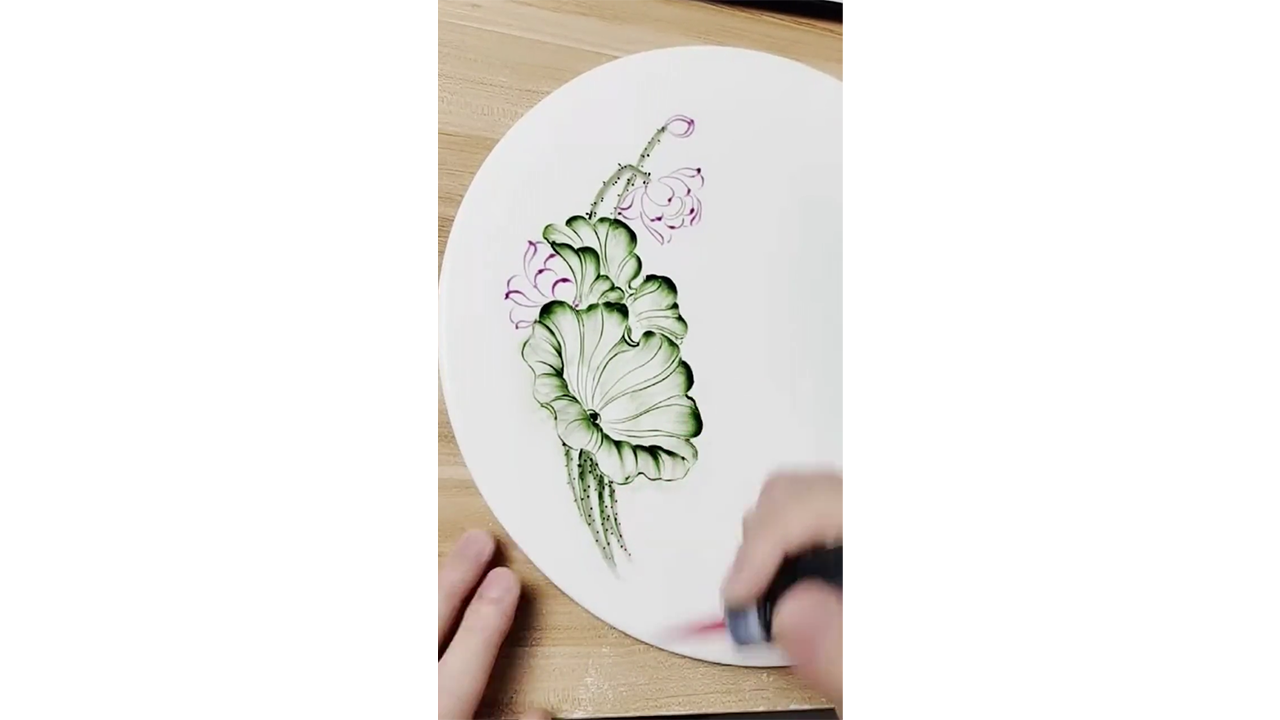Drawing elegant lotus flowers with green ink creating traditional ...