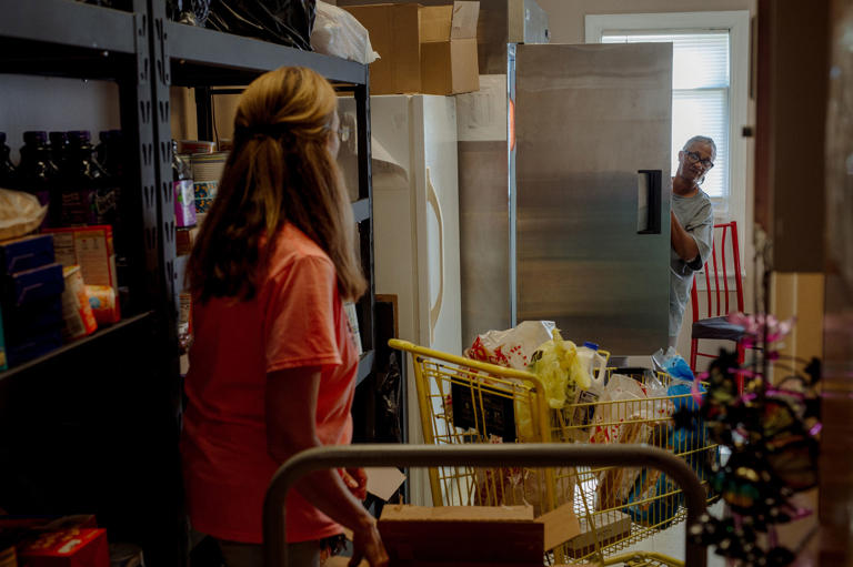 Donna Paterino, left, gathers food for Mary Blackwell, right, at the Widow's Mite Food Pantry on Sept. 15. (Mike Belleme for NBC News)