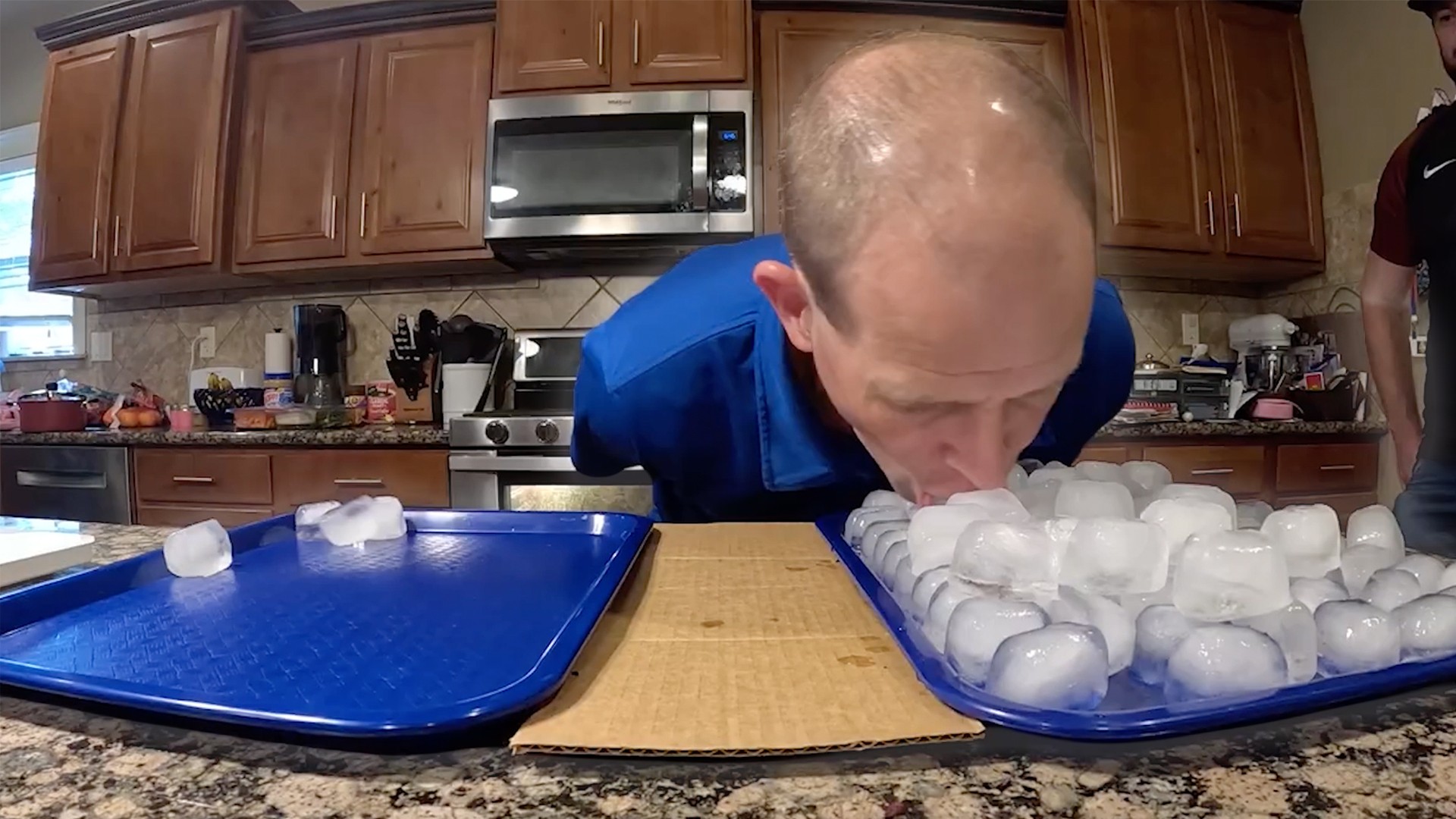 Most ice cubes moved by mouth in one minute - 1.661 kg (58.49 oz) by ...