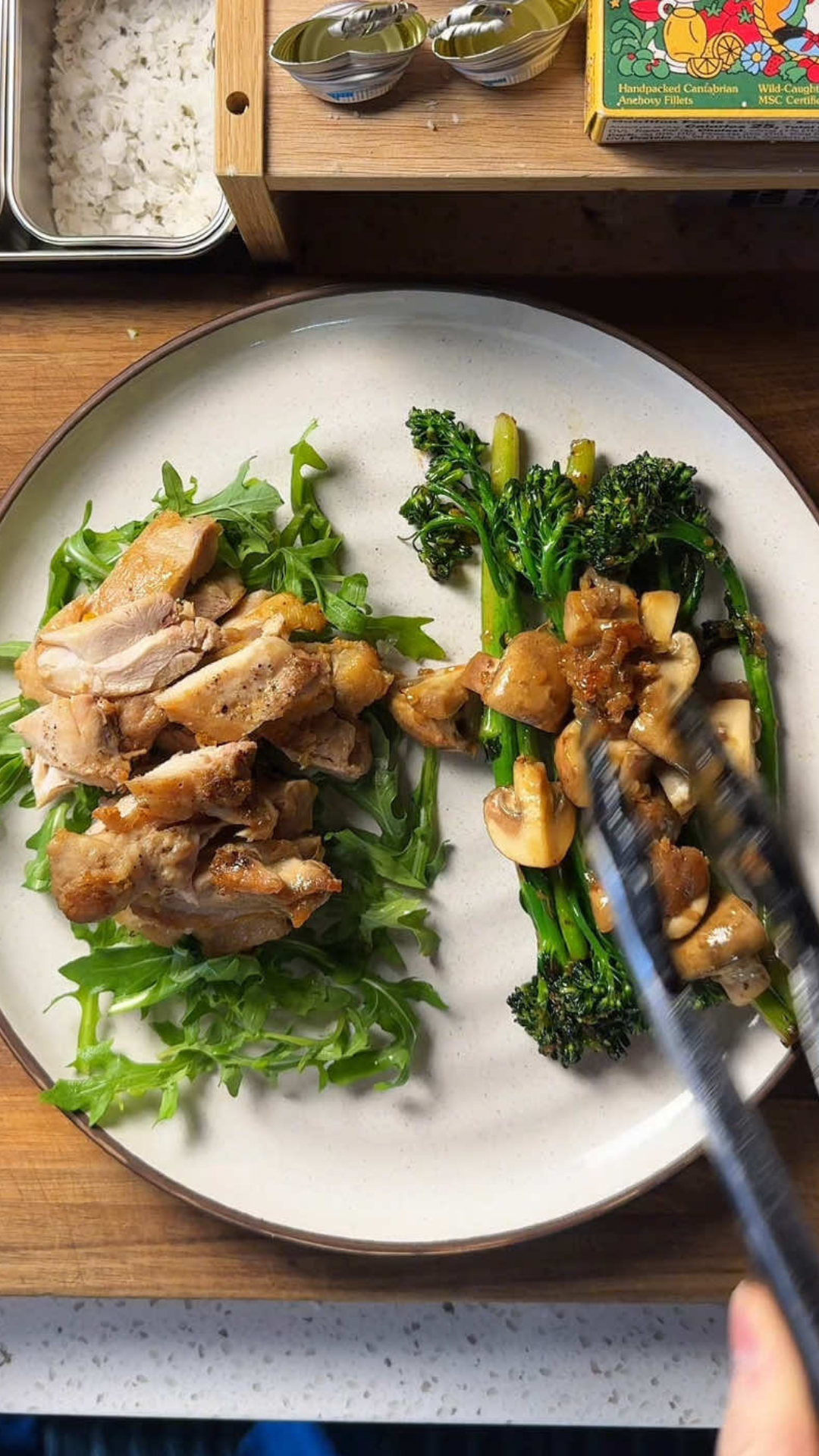 Chicken thighs with arugula and broccolini lunch plate