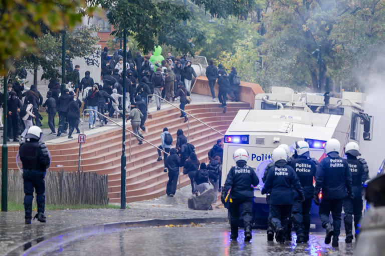 Police and masked protesters clash in Brussels as anti-austerity rally ...