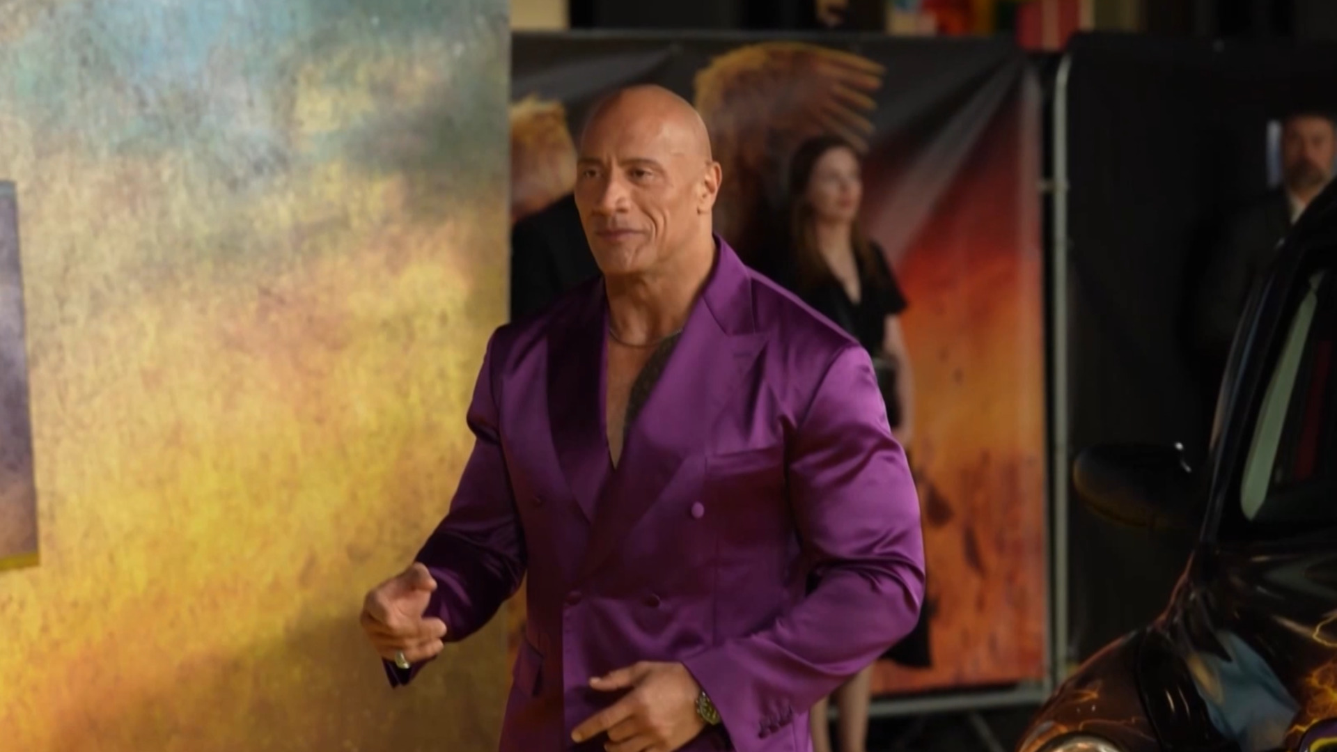 Dwayne Johnson commands attention in bold purple suit