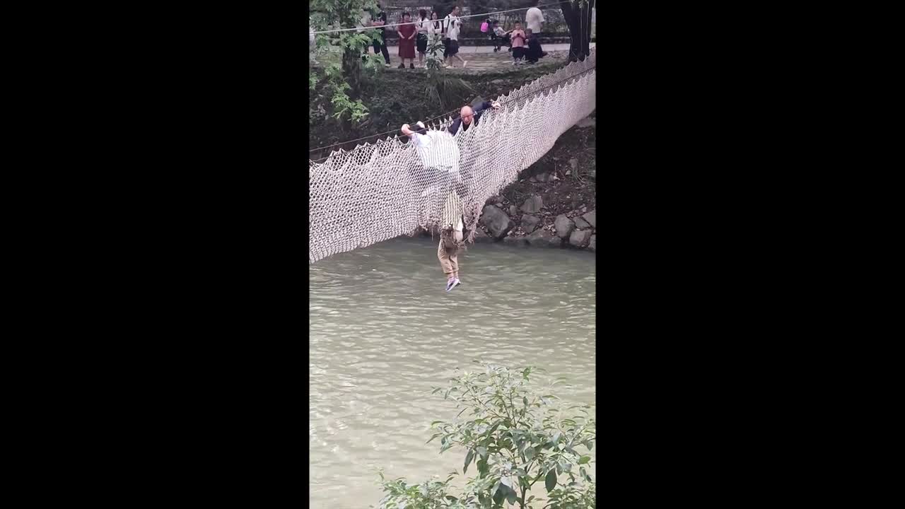 Terrifying moment boy left dangling over river after suspension bridge ...
