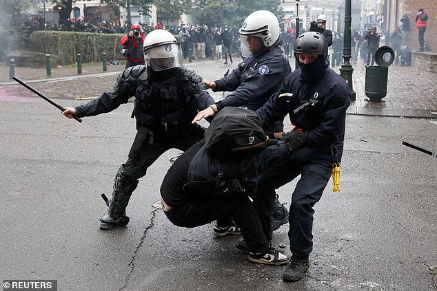Student riots spread to Belgium as hundreds of hooded protesters clash ...