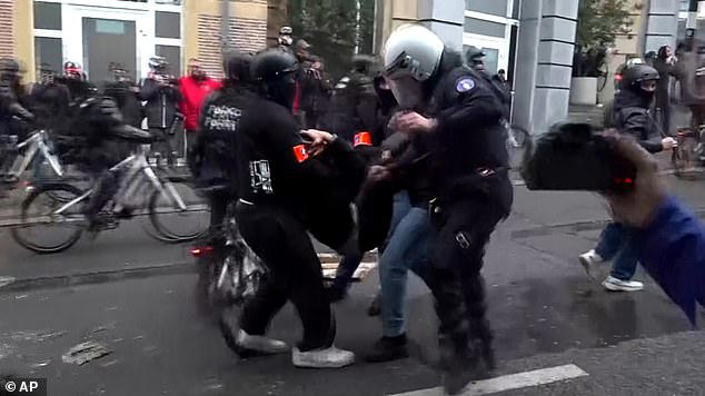 Student riots spread to Belgium as hundreds of hooded protesters clash ...