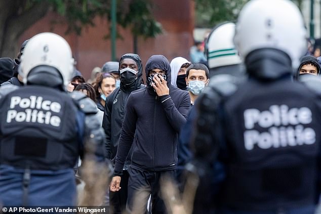 Student riots spread to Belgium as hundreds of hooded protesters clash ...