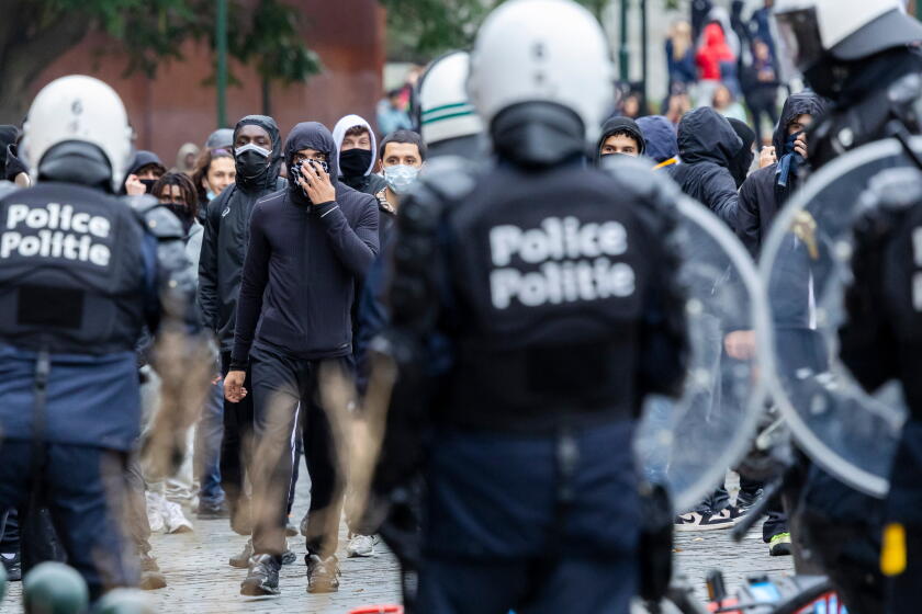 Police and masked protesters clash in Brussels as anti-austerity rally ...