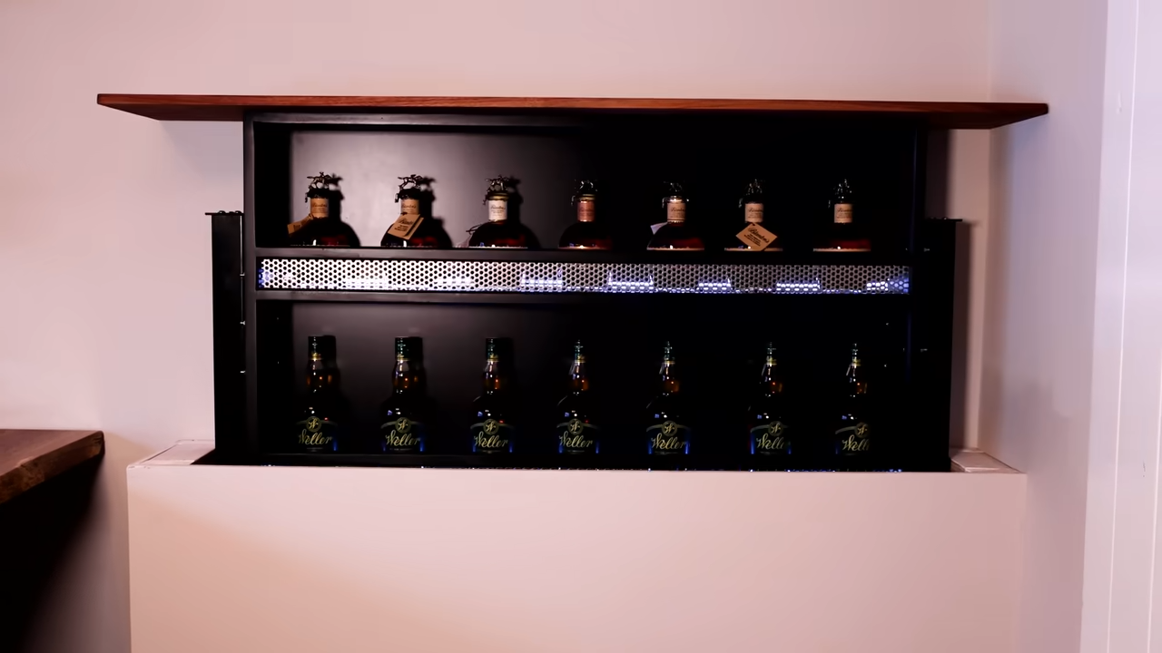 His wife said the bourbon was out of control - so he hid it in the wall