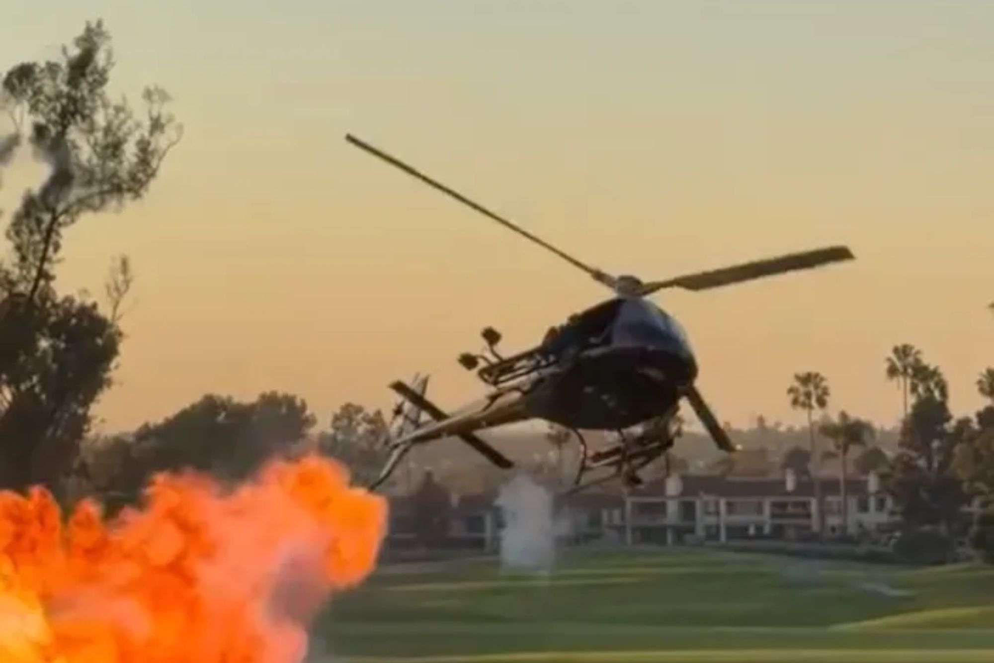 Wild moment swerving helicopter shoots flames and smoke over fancy ...