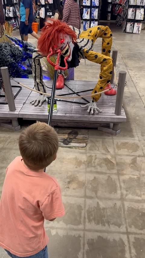 Young boy confronts Halloween animatronics with pitchfork