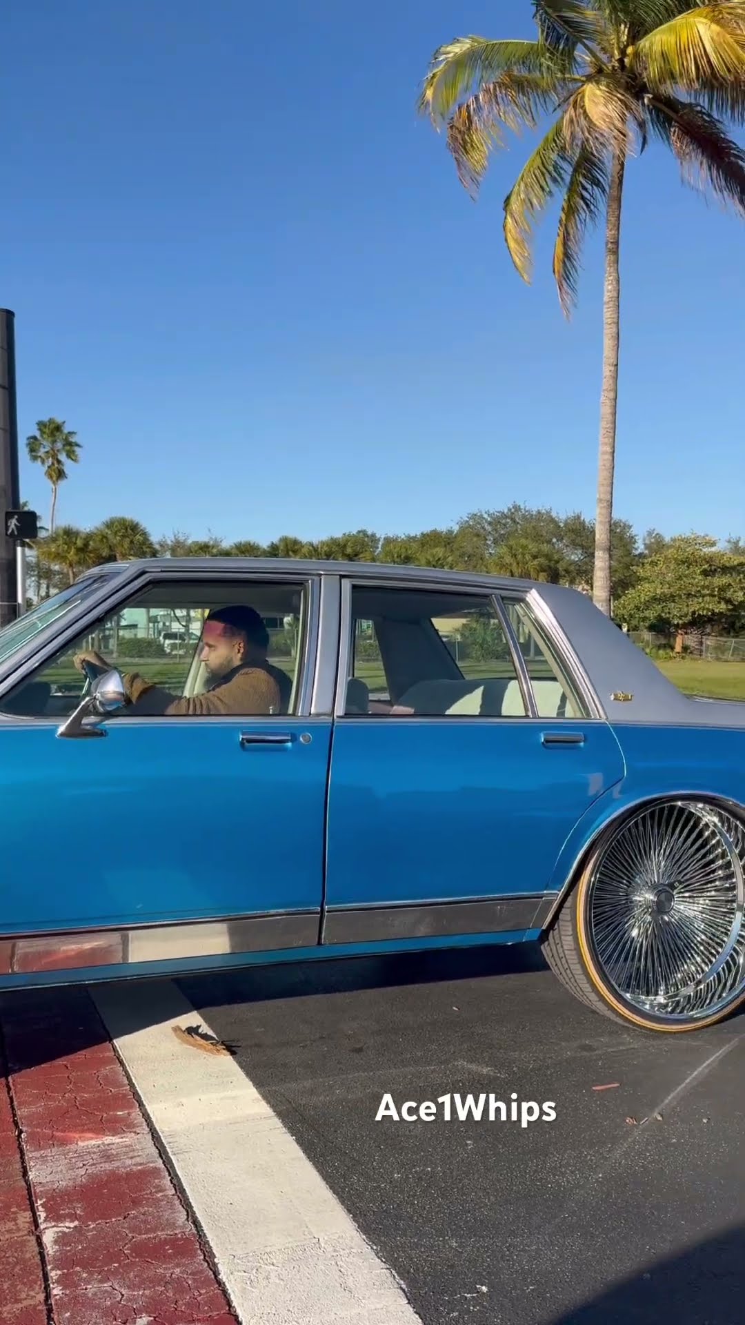 Silver and blue Chevy box on 26’s wire wheels
