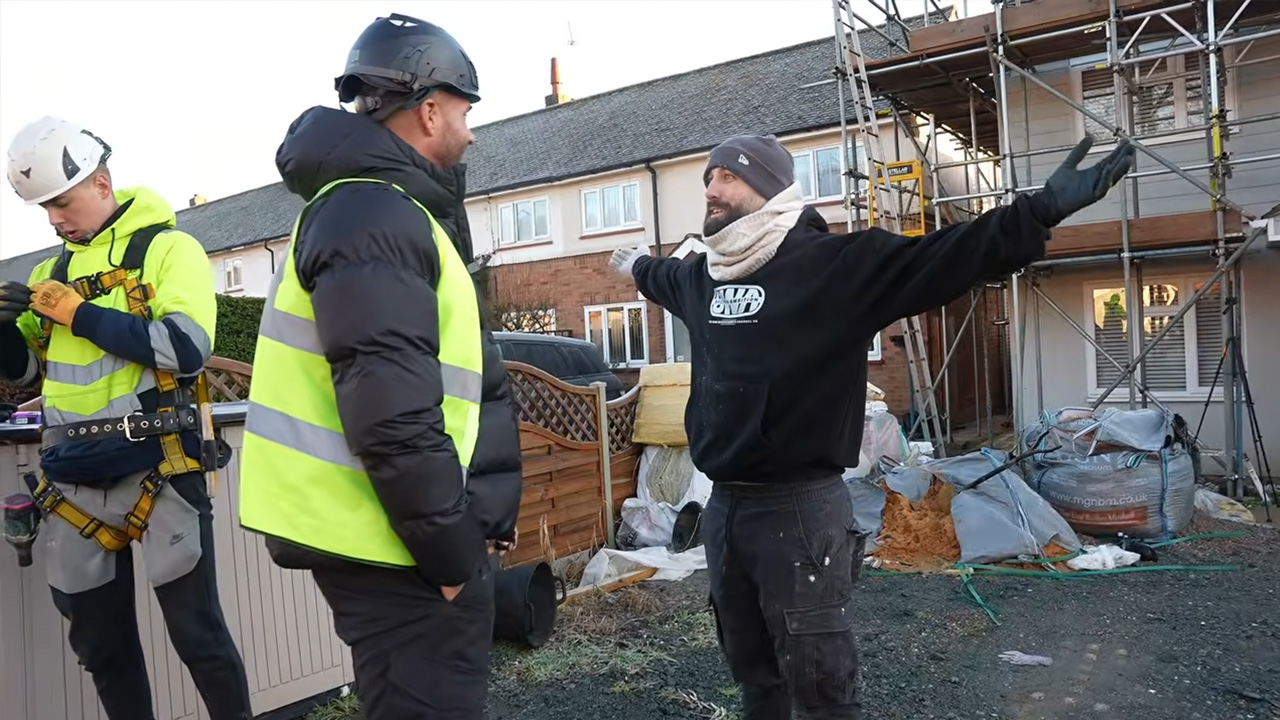 Construction crew tackles structural scaffolding on an exposed house