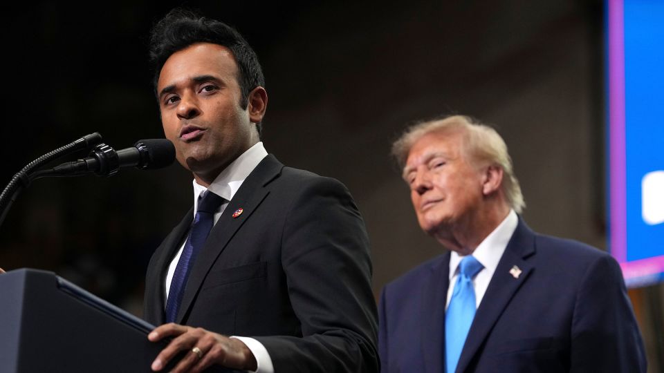 Ohio Republican gubernatorial candidate Vivek Ramaswamy speaks as President Donald Trump listens during an event in Vandalia, Ohio, on October 3. - Mark Schiefelbein/AP