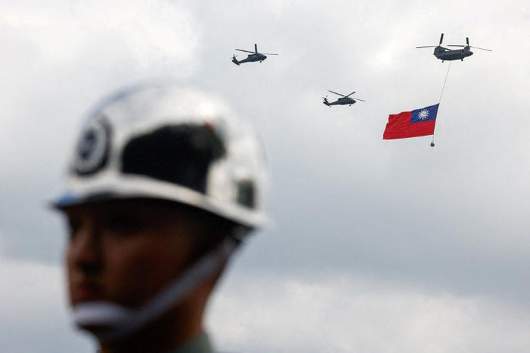 Taiwan military CH-47 Chinook and UH-60M Black Hawk helicopters fly over Taipei as the CH-47 Chinook carries a giant national flag during National Day celebrations in Taipei, Taiwan, October 10, 2026. REUTERS/Ann Wang