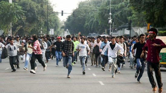 Protesters being dispersed by Delhi Police amid CJP Protest at Connaught Place, in New Delhi on Saturday.