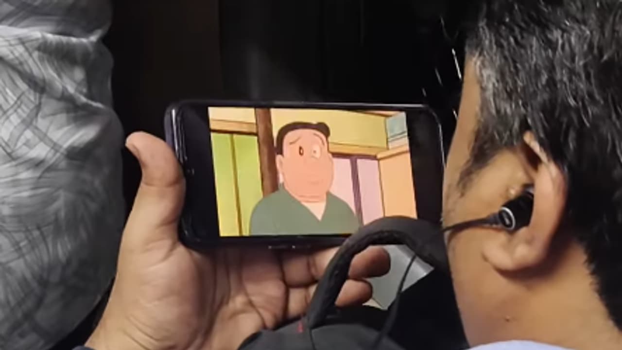 Viral video: Man watches Doraemon in crowded local train (watch)