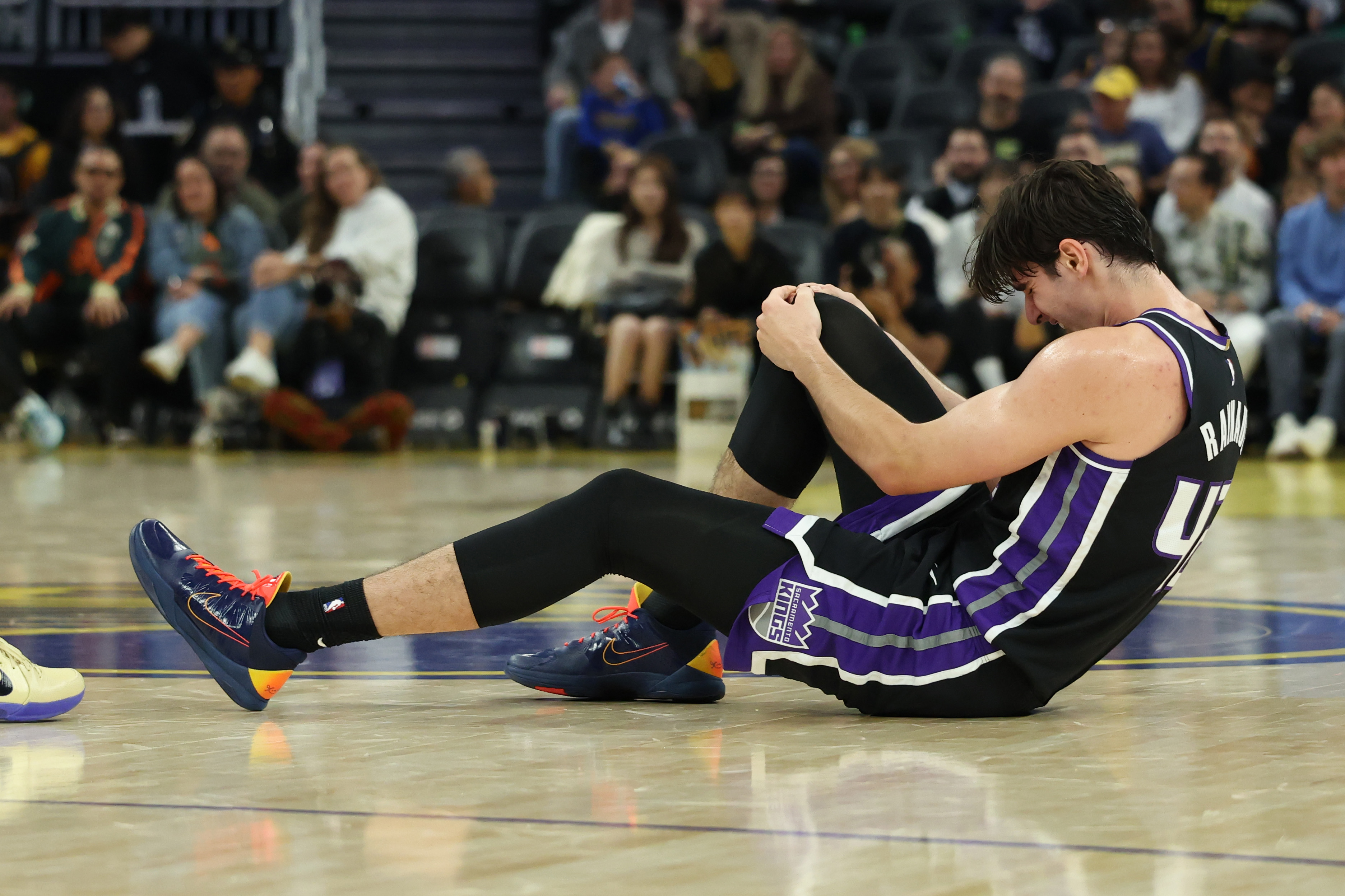 Kings center Maxime Raynaud taken off court in wheelchair after going ...