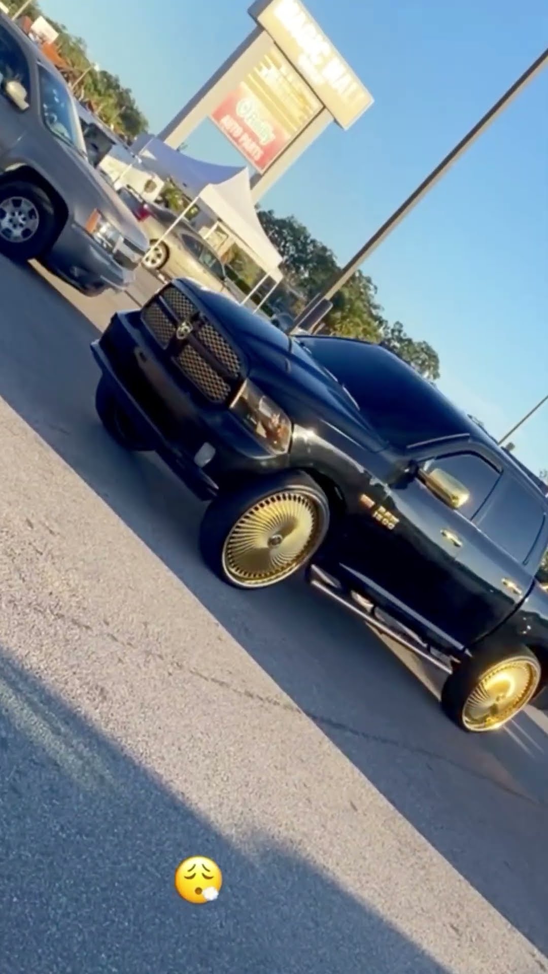 Black Dodge Charger and Dodge Ram 1500 on gold 30” DUB floaters